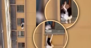 صورة سيدة تتسلق ناطحة سحاب بلباس النوم للهروب من زوجة عشيقها