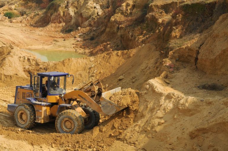 A worker drives a skip loader while working at the site of a rare earth metals mine at Nancheng county, Jiangxi province October 31, 2010. China told the United States on Saturday it would not withhold rare earth minerals but the two nations did not appear to make headway on disputes over North Korea and regional territorial claims. REUTERS/Stringer (CHINA - Tags: ENERGY ENVIRONMENT BUSINESS) CHINA OUT. NO COMMERCIAL OR EDITORIAL SALES IN CHINA
