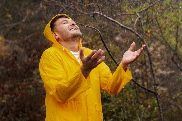 Rain portrait of young man in rain coat freepik