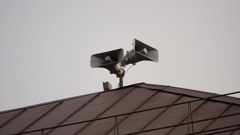 Street loudspeakers, street sirens in case of war, bombing. Howling siren, warning of air danger, the need to go down to a bomb shelter in Israel, Europe
